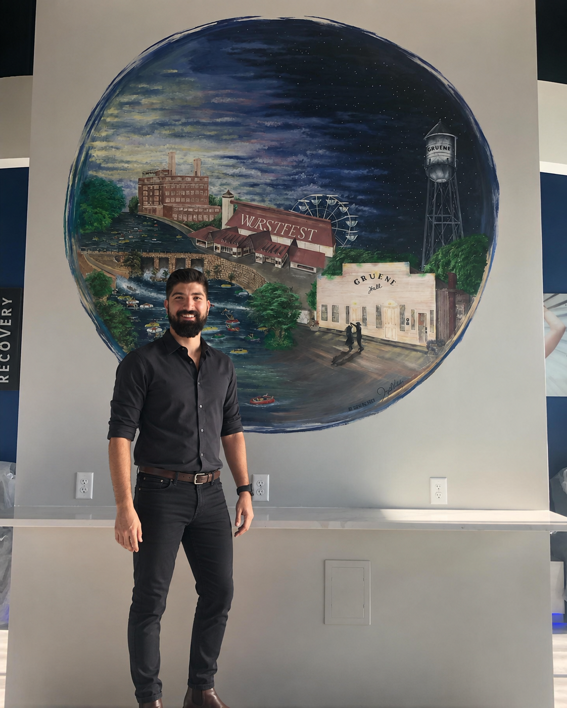 Joseph Valadez standing before his New Braunfels mural